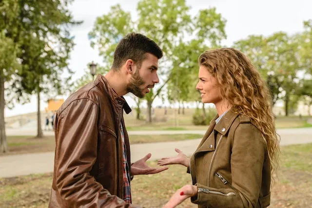 A couple quarrelling in a park